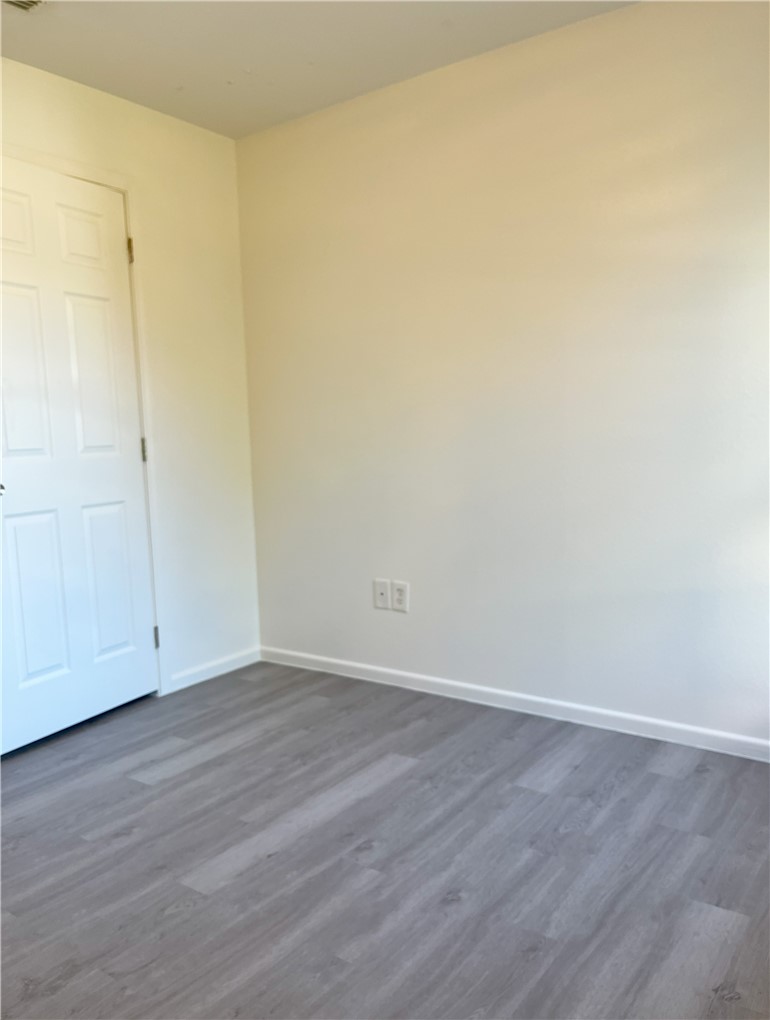 1802 16th Street, Unit B Corpus Christi, TX 78404 - Photo 12 of 17 a view of an empty room with wooden floor