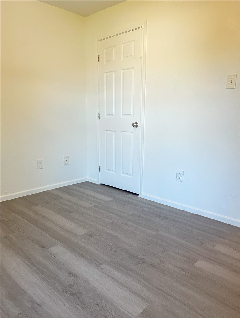1802 16th Street, Unit B Corpus Christi, TX 78404 - Photo 16 of 17 an empty room with wooden floor