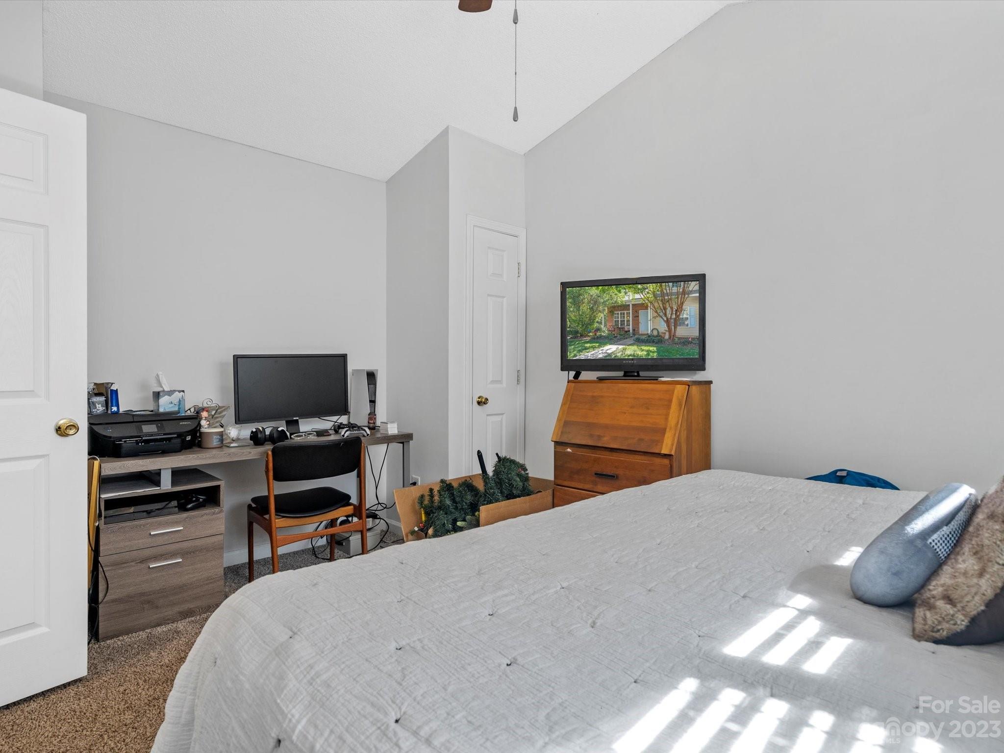 8162 Rudolph Road Charlotte, NC 28216 - Photo 12 of 17 a bedroom with a bed and a flat screen tv