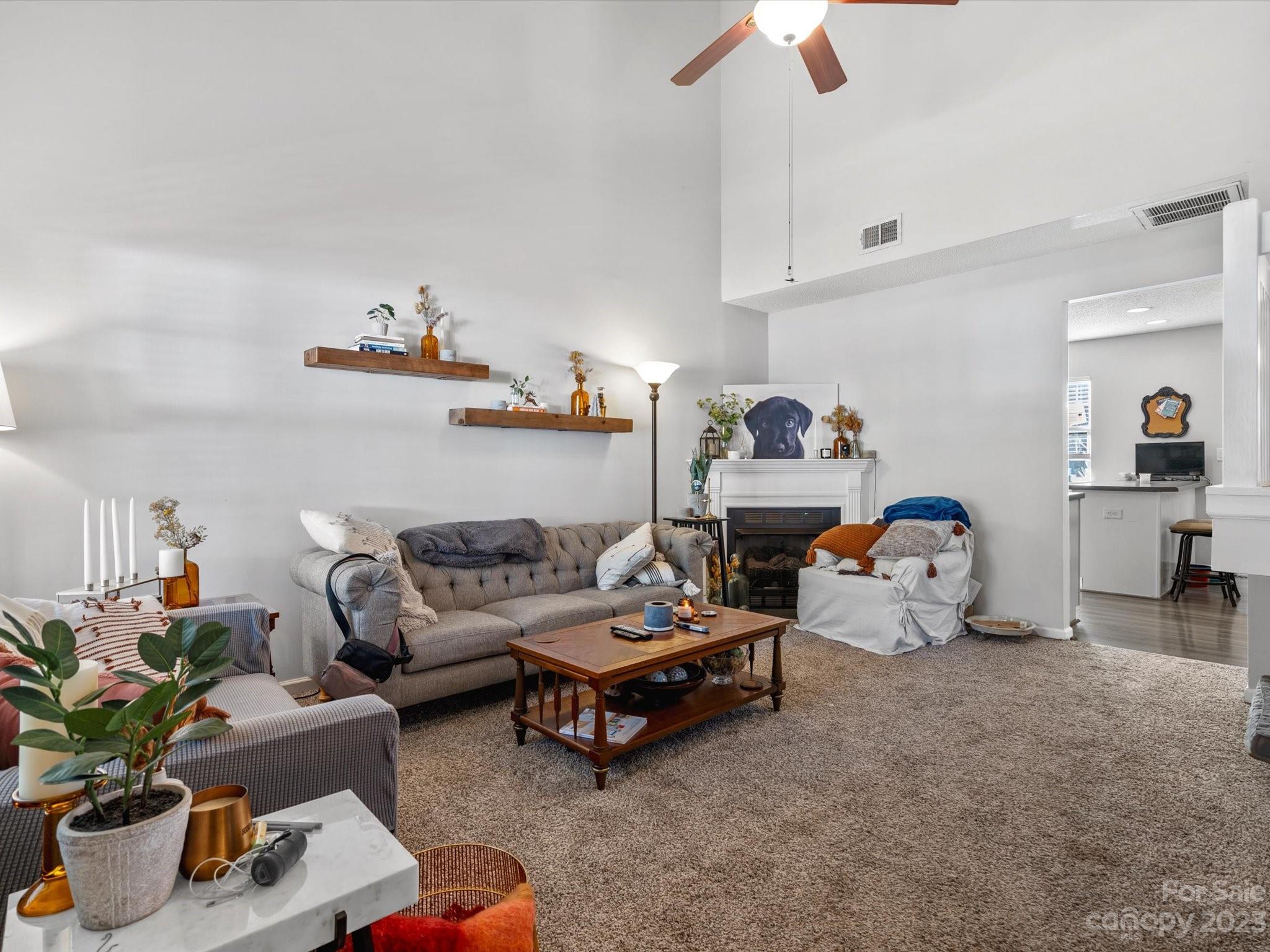 8162 Rudolph Road Charlotte, NC 28216 - Photo 2 of 17 a living room with furniture and a chandelier