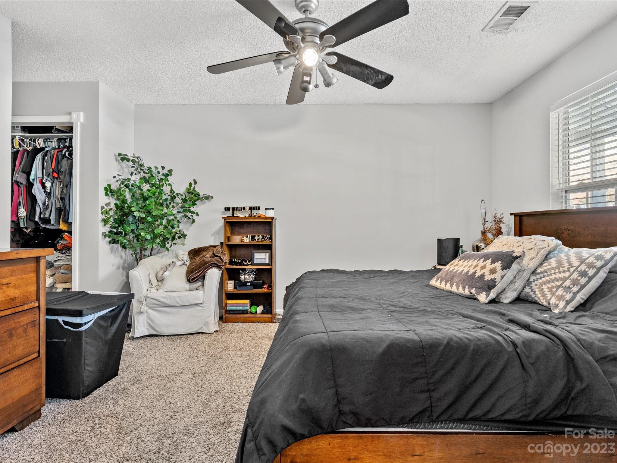 8162 Rudolph Road Charlotte, NC 28216 - Photo 5 of 17 a bedroom with a bed couch and window