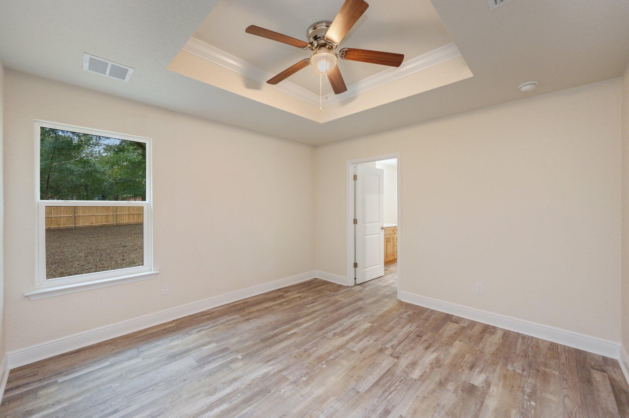 609 East Chestnut Avenue Crestview, FL 32539 - Photo 13 of 31 wooden floor in an empty room with a window