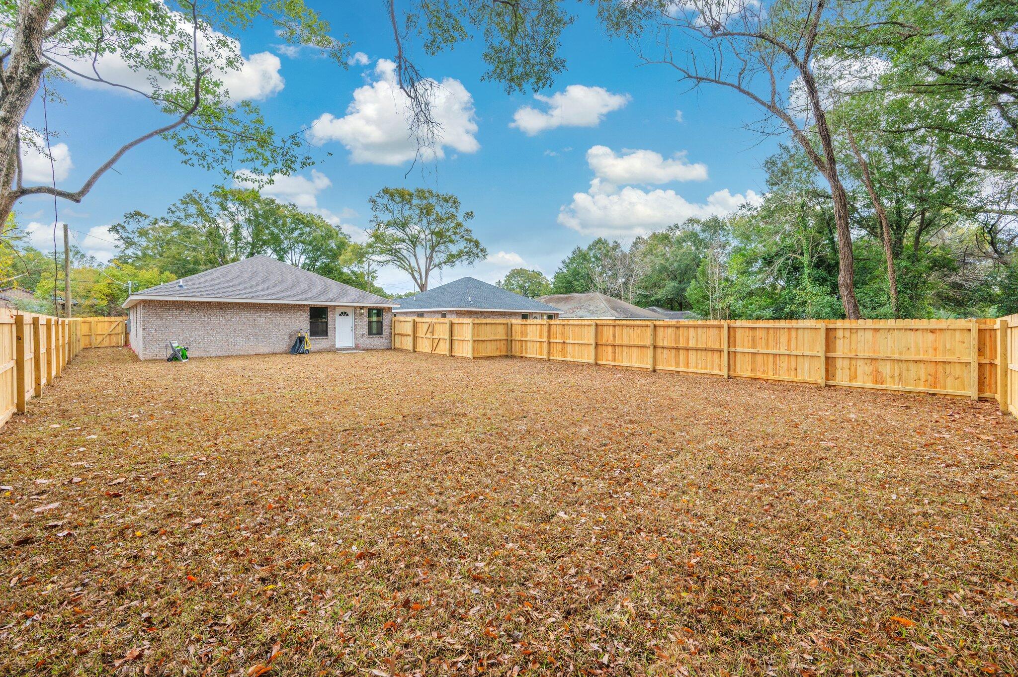 609 East Chestnut Avenue Crestview, FL 32539 - Photo 28 of 31 a view of backyard with a garden and outdoor seating