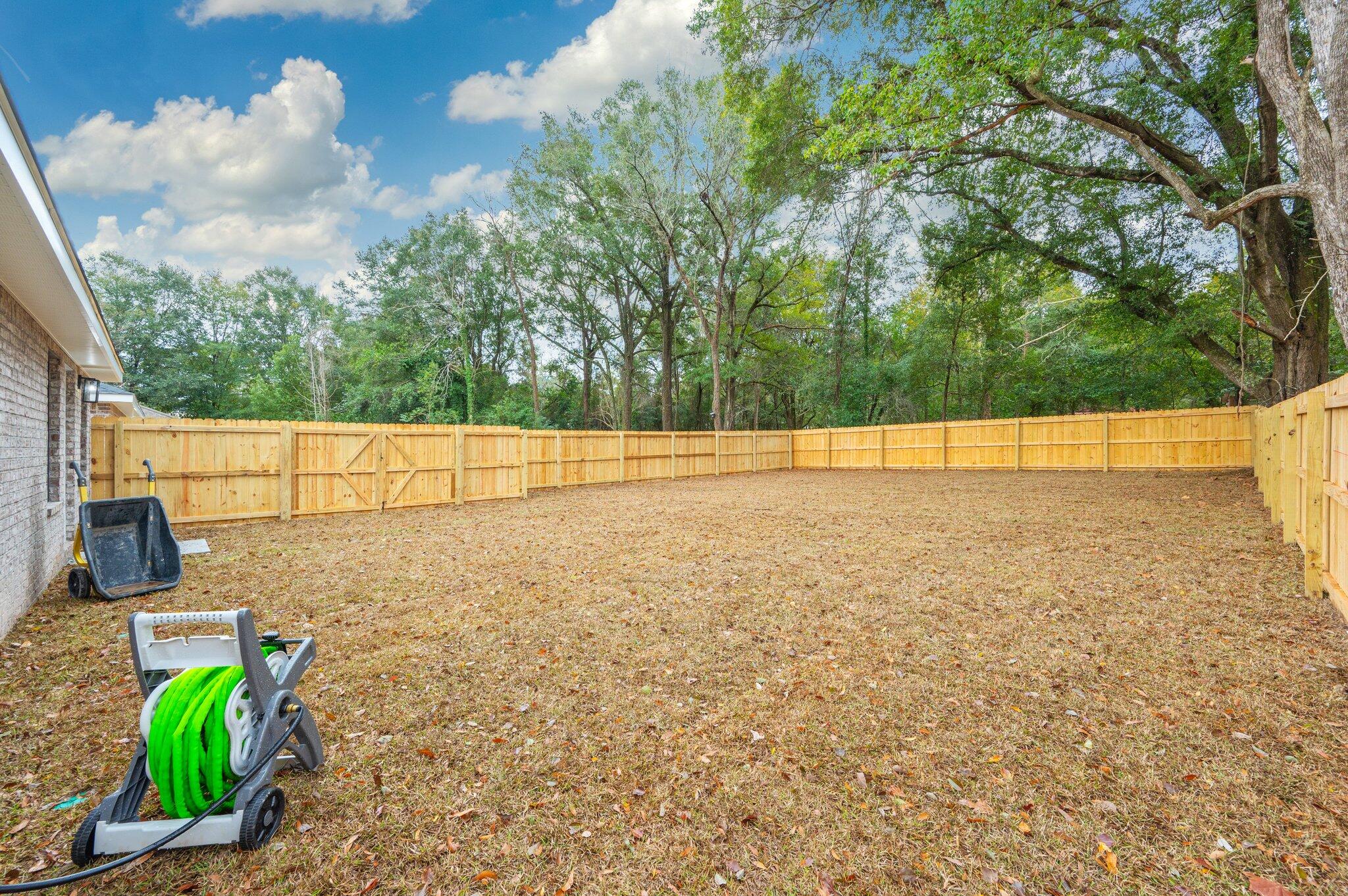 609 East Chestnut Avenue Crestview, FL 32539 - Photo 29 of 31 a view of a garden with an outdoor seating