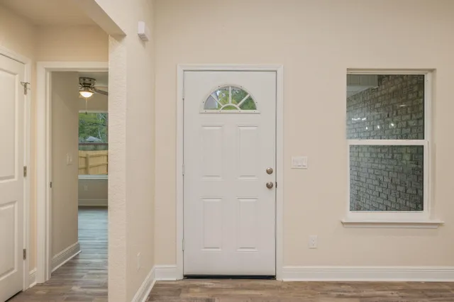 a view of an entryway with wooden floor