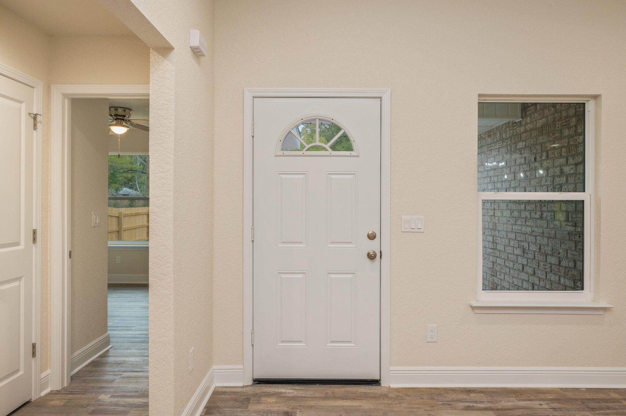 609 East Chestnut Avenue Crestview, FL 32539 - Photo 5 of 31 a view of an entryway with wooden floor