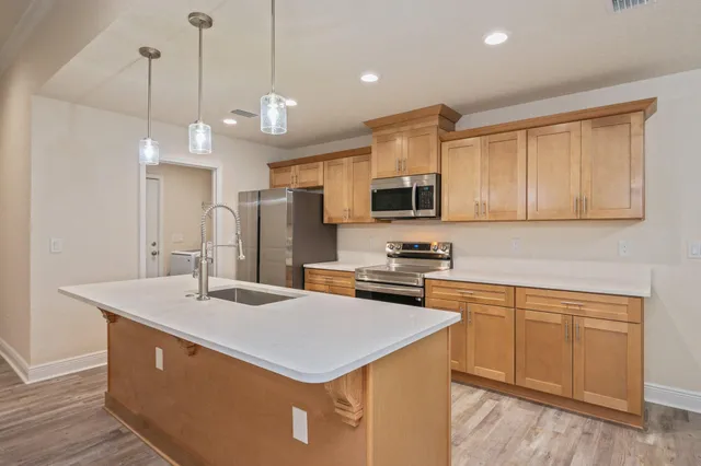 a view of kitchen with wooden floor and window