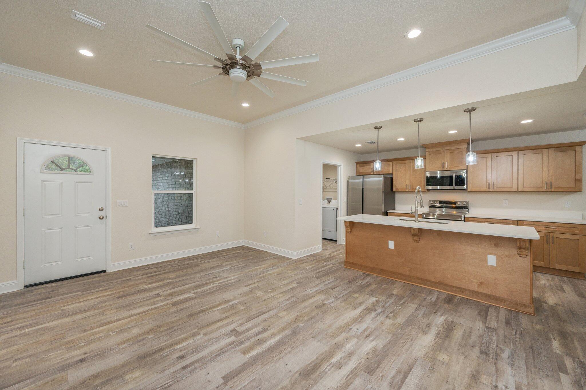 609 East Chestnut Avenue Crestview, FL 32539 - Photo 9 of 31 a view of kitchen with wooden floor and window