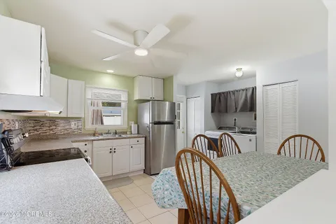 a kitchen with granite countertop a sink stainless steel appliances and cabinets
