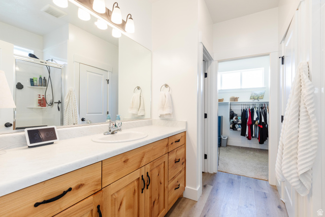 349 West 3085 South Logan, UT 84321 - Photo 15 of 37 Bathroom featuring a light wood vanity with black hardware, an integrated sink, and a large wall mirror