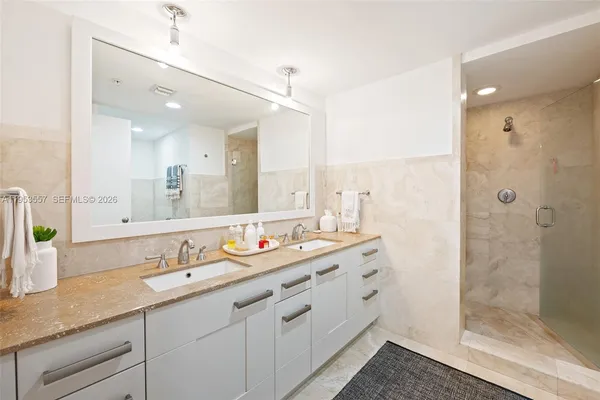 a bathroom with double sink and a mirror