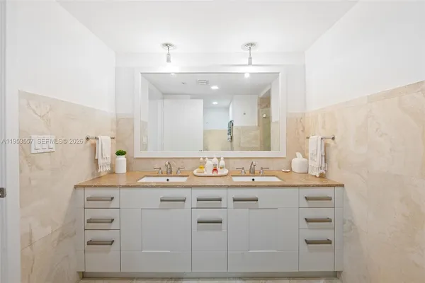 a bathroom with a sink vanity and mirror