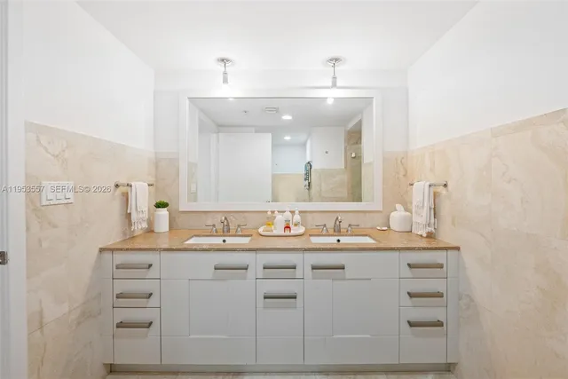 a bathroom with a sink vanity and mirror