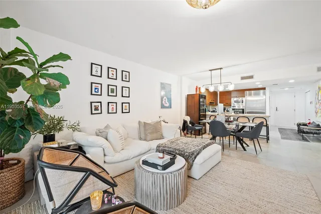 a living room with furniture and a painting on the wall
