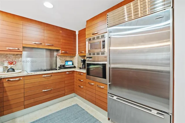 a kitchen with granite countertop stainless steel appliances and counter space
