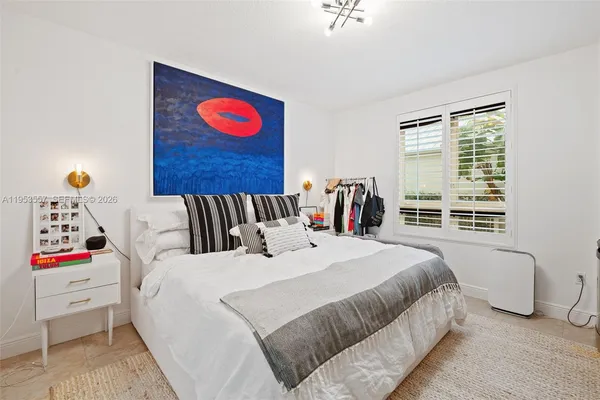 a bedroom with bed and a window