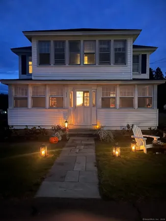 a front view of a house with a garden