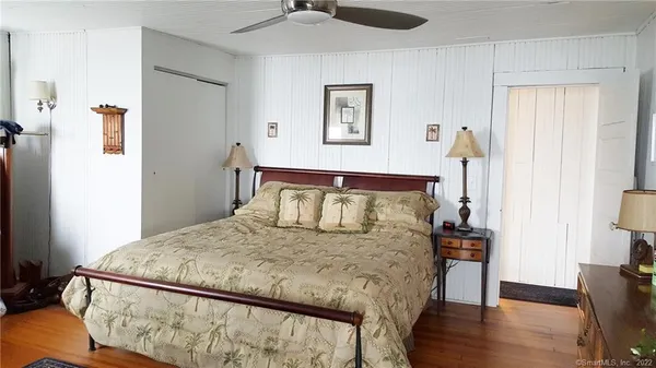 a bedroom with a bed dresser and a window