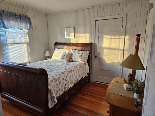 a bedroom with a bed and a chair