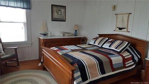 a bedroom with a bed and a window