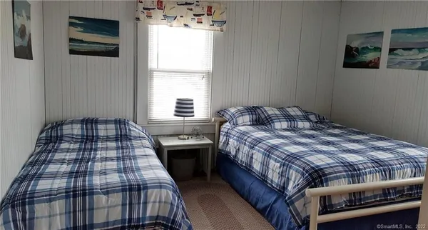 a bedroom with a bed and window