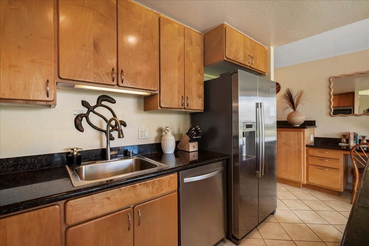 2936 South Kihei Road, Unit 213 Kihei, HI 96753 - Photo 14 of 50 a kitchen with stainless steel appliances granite countertop a sink a refrigerator and a stove top oven