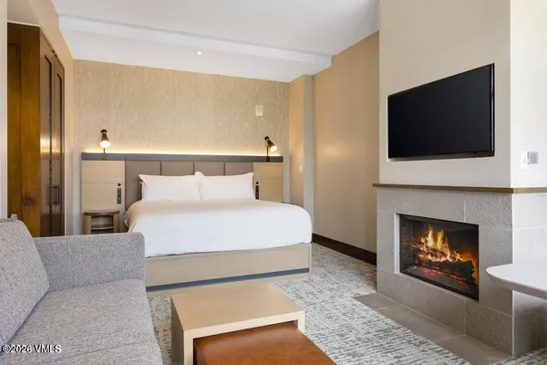 a bedroom with a bed and a fireplace