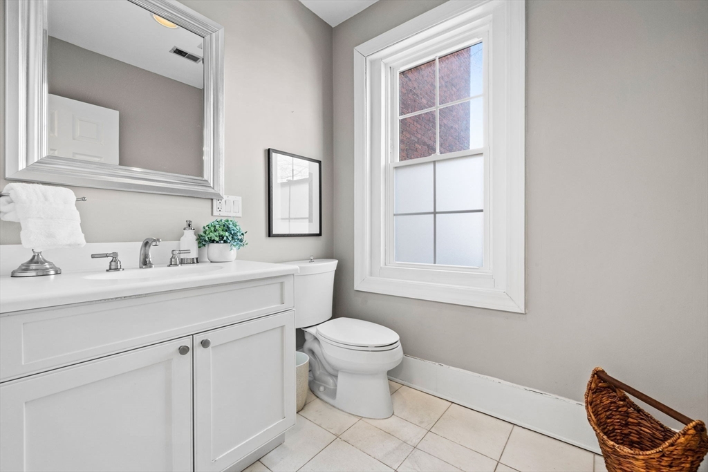 20 Sullivan Street, Unit 2 Boston, MA 02129 - Photo 13 of 25 a bathroom with a toilet sink and mirror