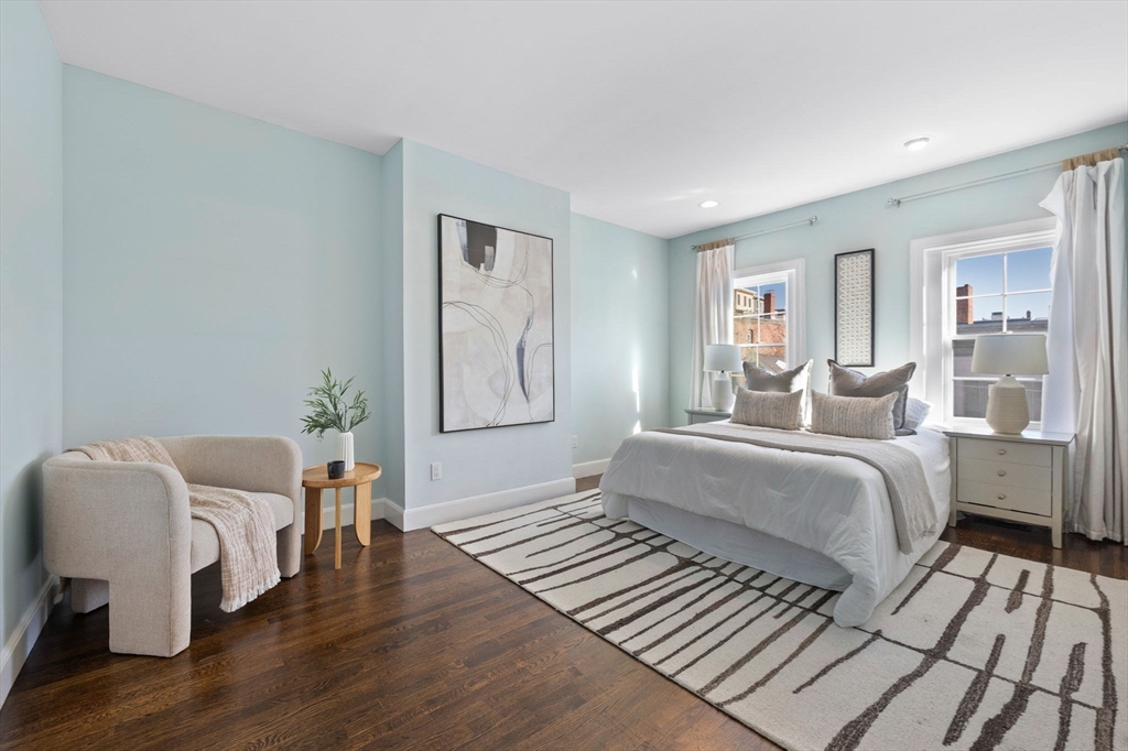 20 Sullivan Street, Unit 2 Boston, MA 02129 - Photo 14 of 25 a spacious bedroom with a bed and wooden floor