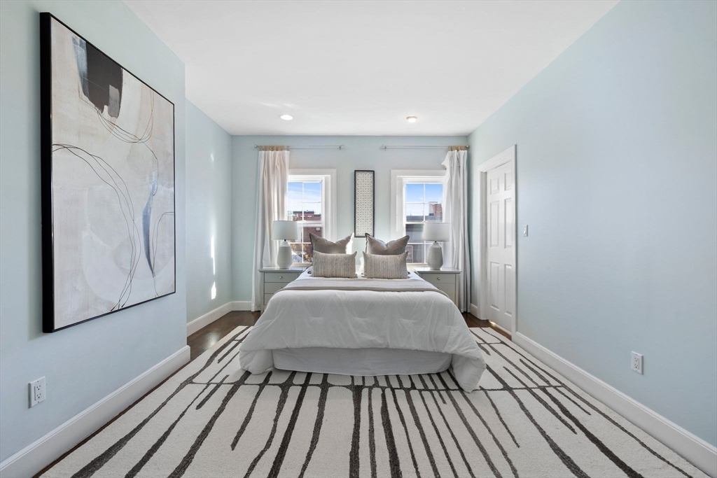 20 Sullivan Street, Unit 2 Boston, MA 02129 - Photo 15 of 25 a view of a bedroom with wooden floor and furniture
