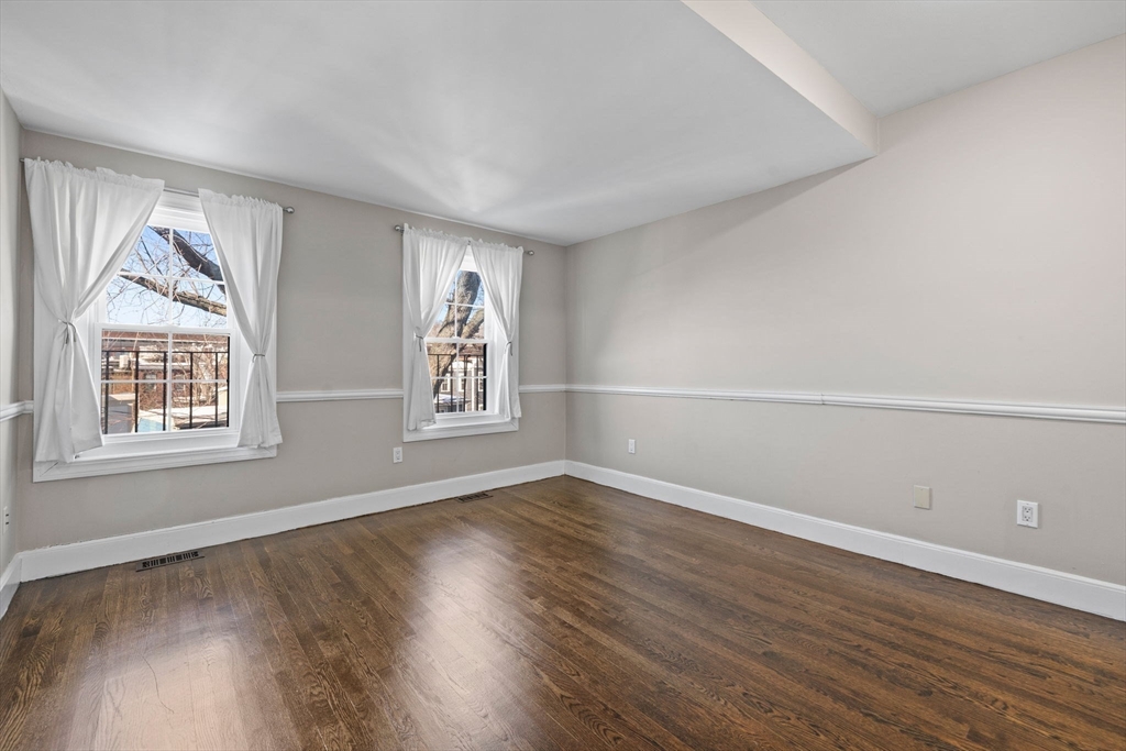 20 Sullivan Street, Unit 2 Boston, MA 02129 - Photo 18 of 25 an empty room with wooden floor and windows
