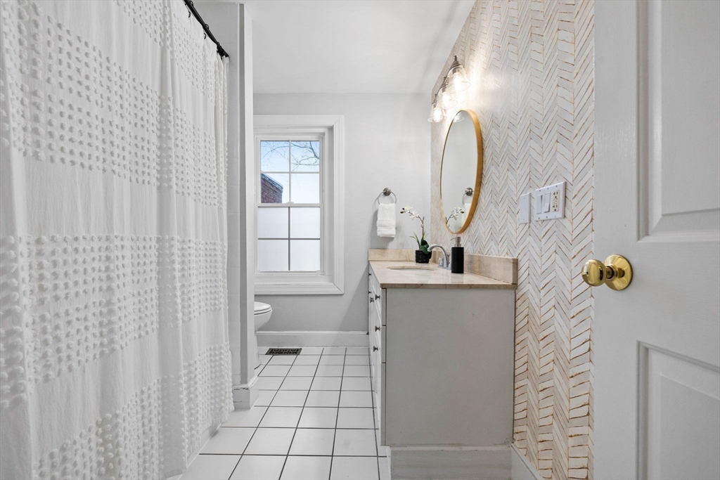 20 Sullivan Street, Unit 2 Boston, MA 02129 - Photo 20 of 25 a bathroom with a sink a toilet and a mirror