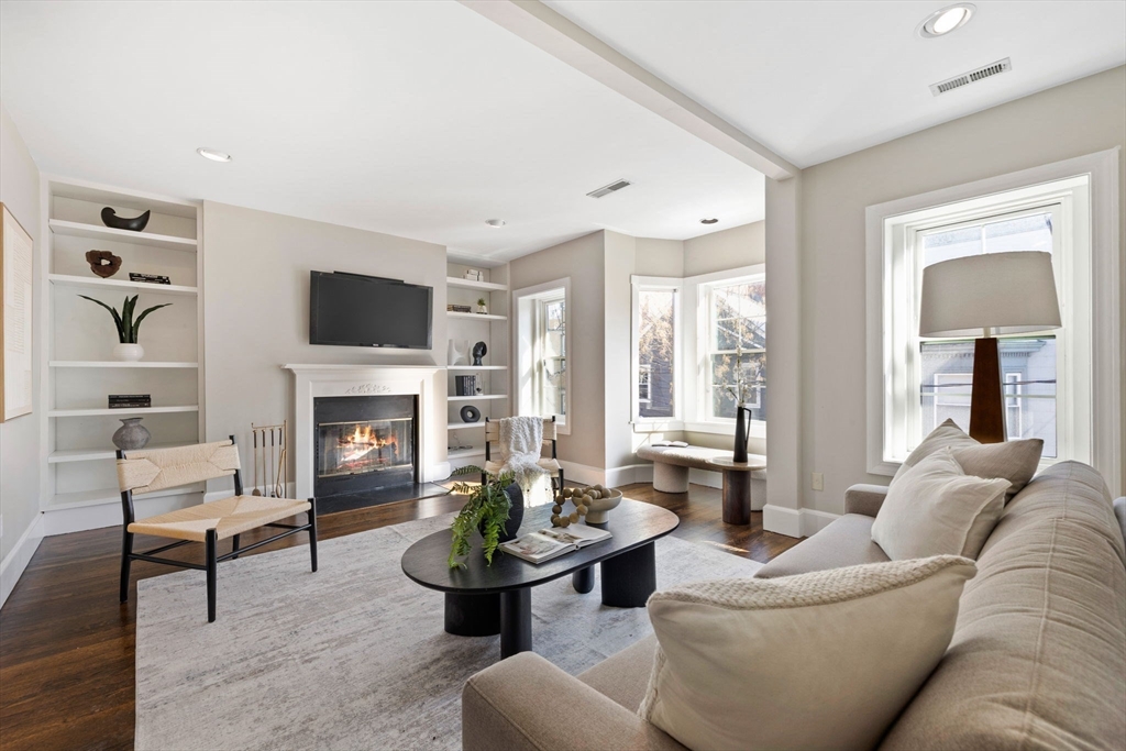 20 Sullivan Street, Unit 2 Boston, MA 02129 - Photo 4 of 25 a living room with furniture a fireplace and a flat screen tv