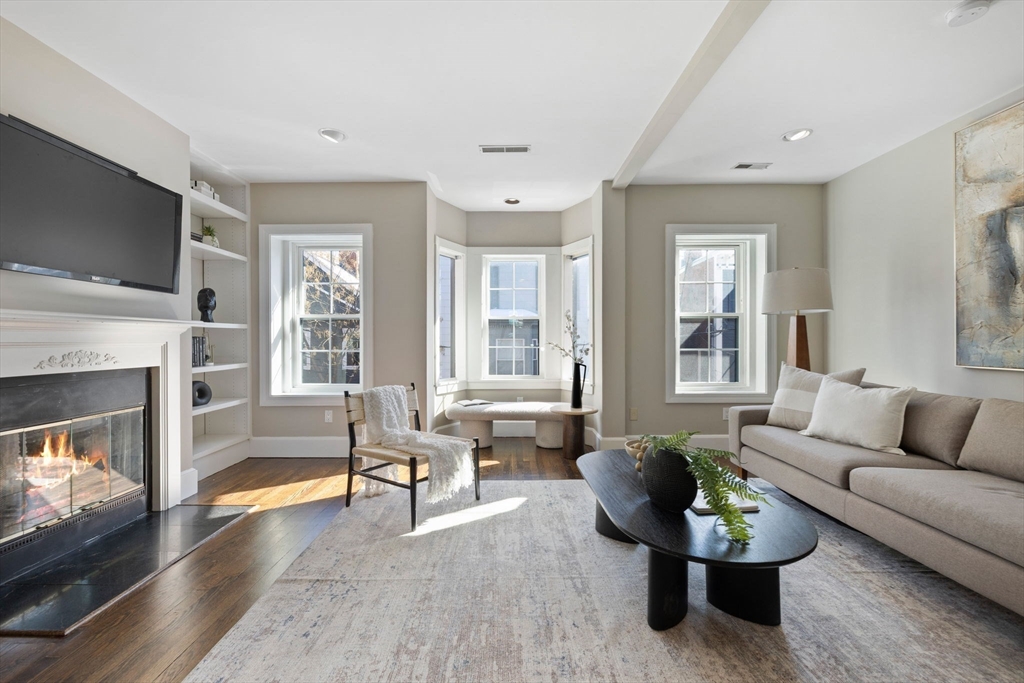 20 Sullivan Street, Unit 2 Boston, MA 02129 - Photo 5 of 25 a living room with furniture flat screen tv and a fireplace