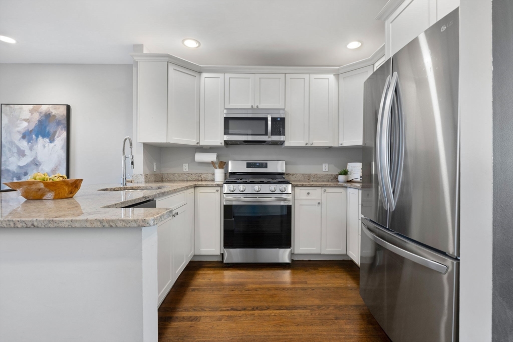 20 Sullivan Street, Unit 2 Boston, MA 02129 - Photo 8 of 25 a kitchen with stainless steel appliances granite countertop a refrigerator sink and stove