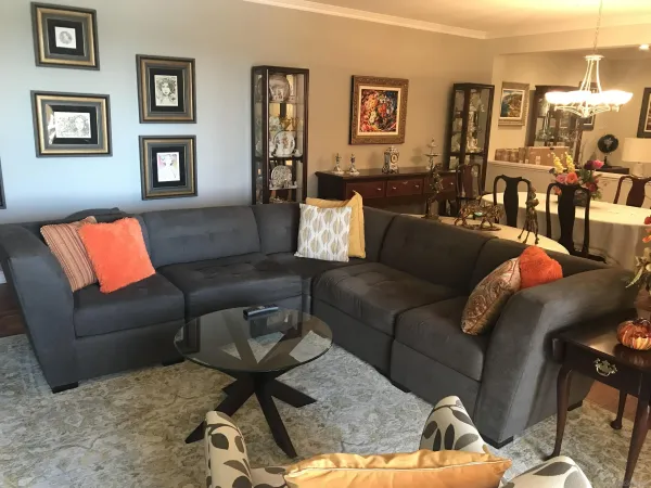 a living room with furniture and wooden floor