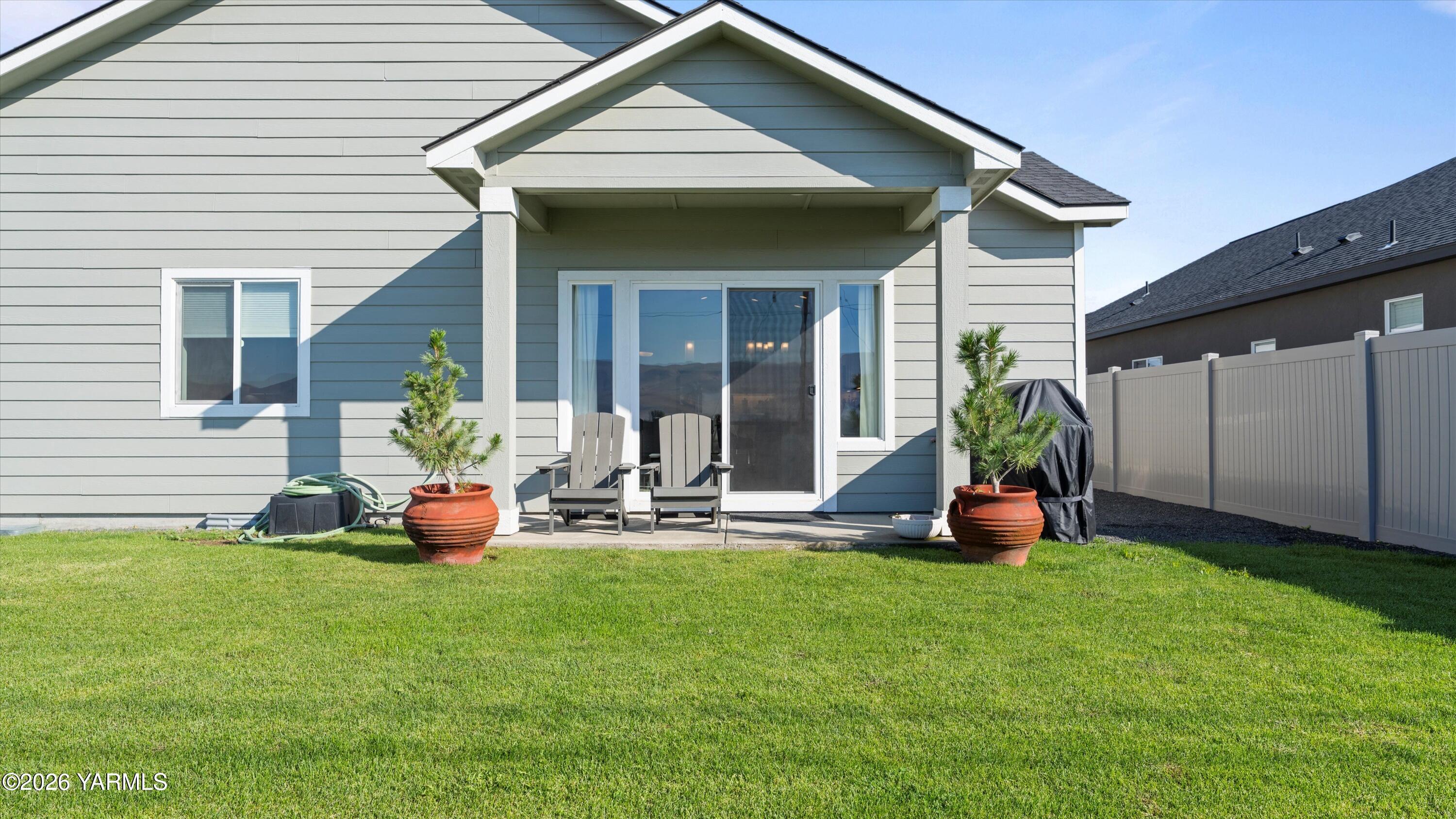 208 Bratton Street Prosser, WA 99350 - Photo 34 of 36 a front view of a house with outdoor seating and yard