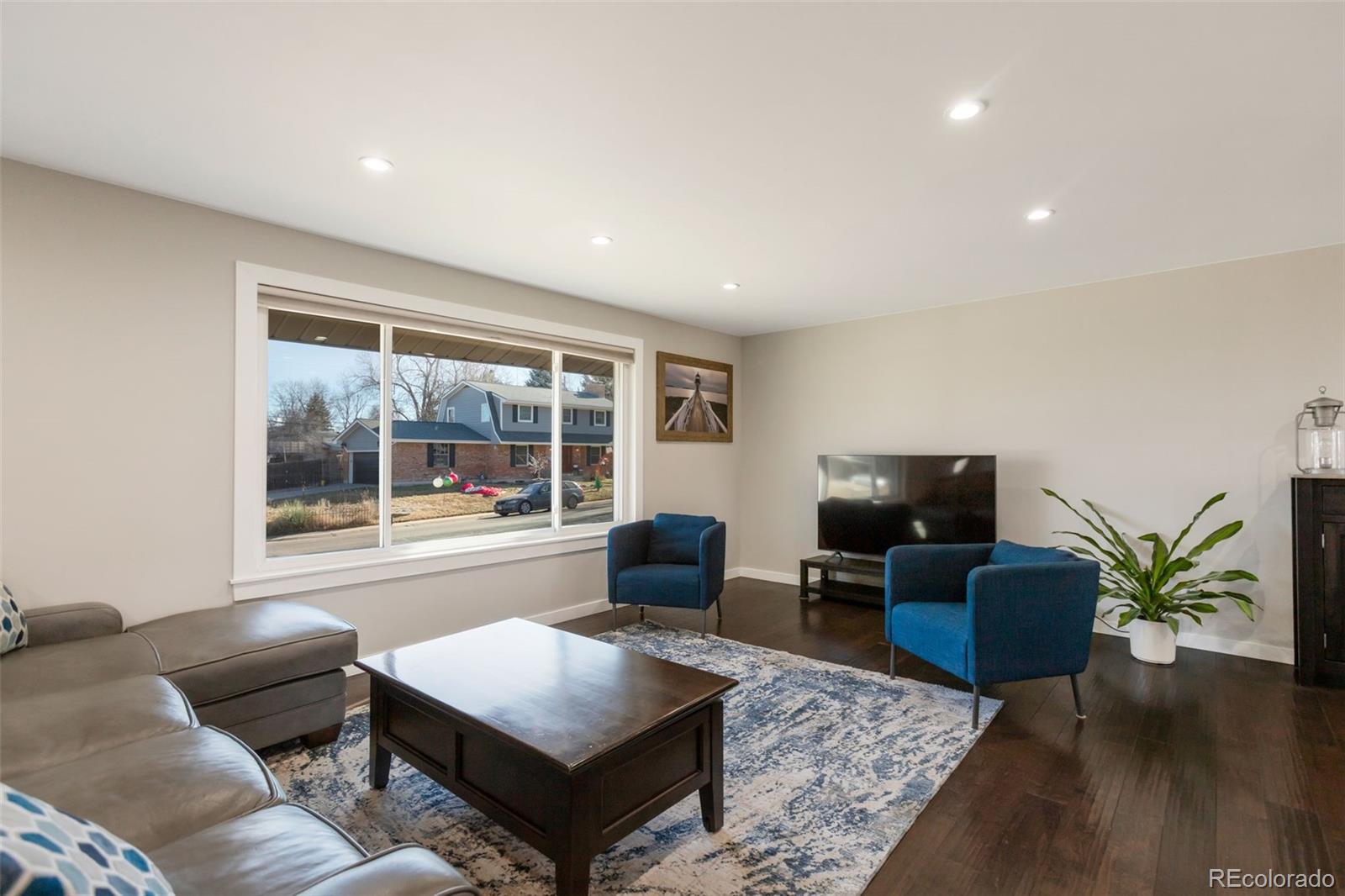 6221 South Logan Court Centennial, CO 80121 - Photo 11 of 30 a living room with furniture and a flat screen tv