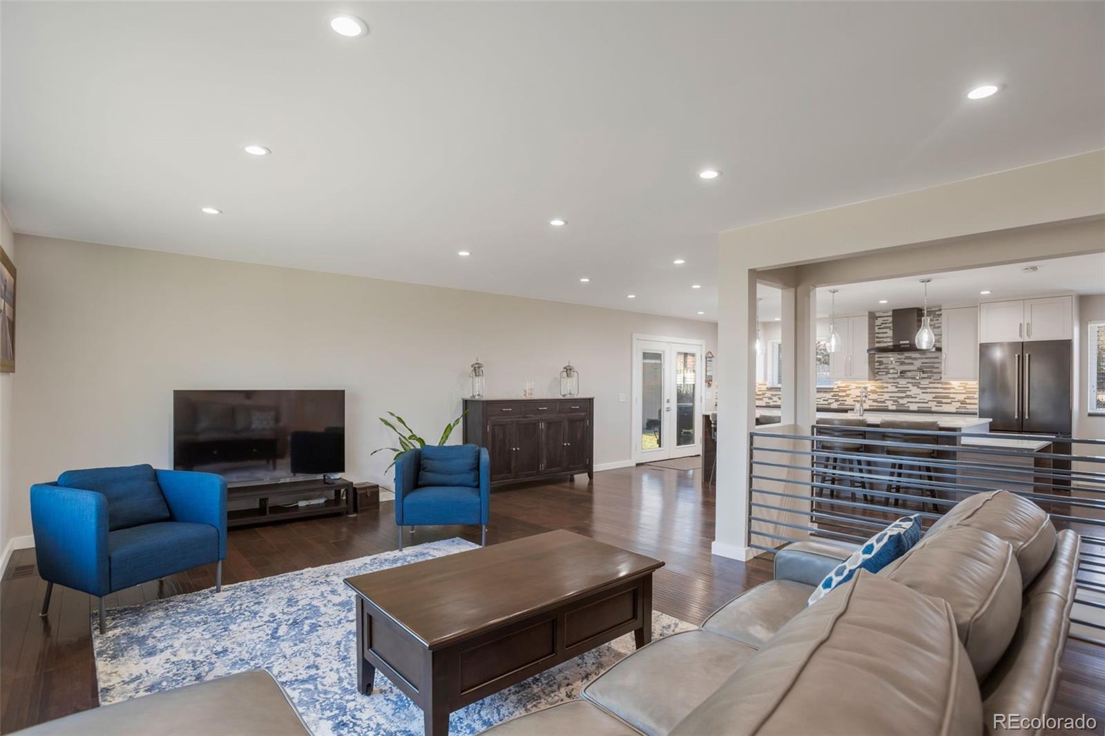 6221 South Logan Court Centennial, CO 80121 - Photo 14 of 30 a living room with furniture and a flat screen tv