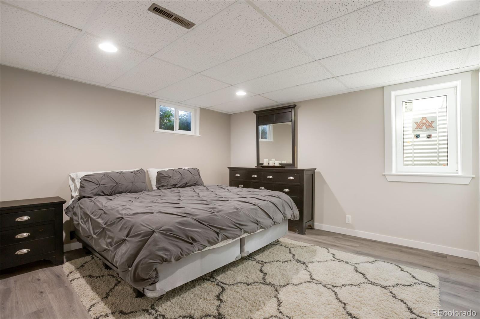 6221 South Logan Court Centennial, CO 80121 - Photo 15 of 30 a spacious bedroom with a bed and a window