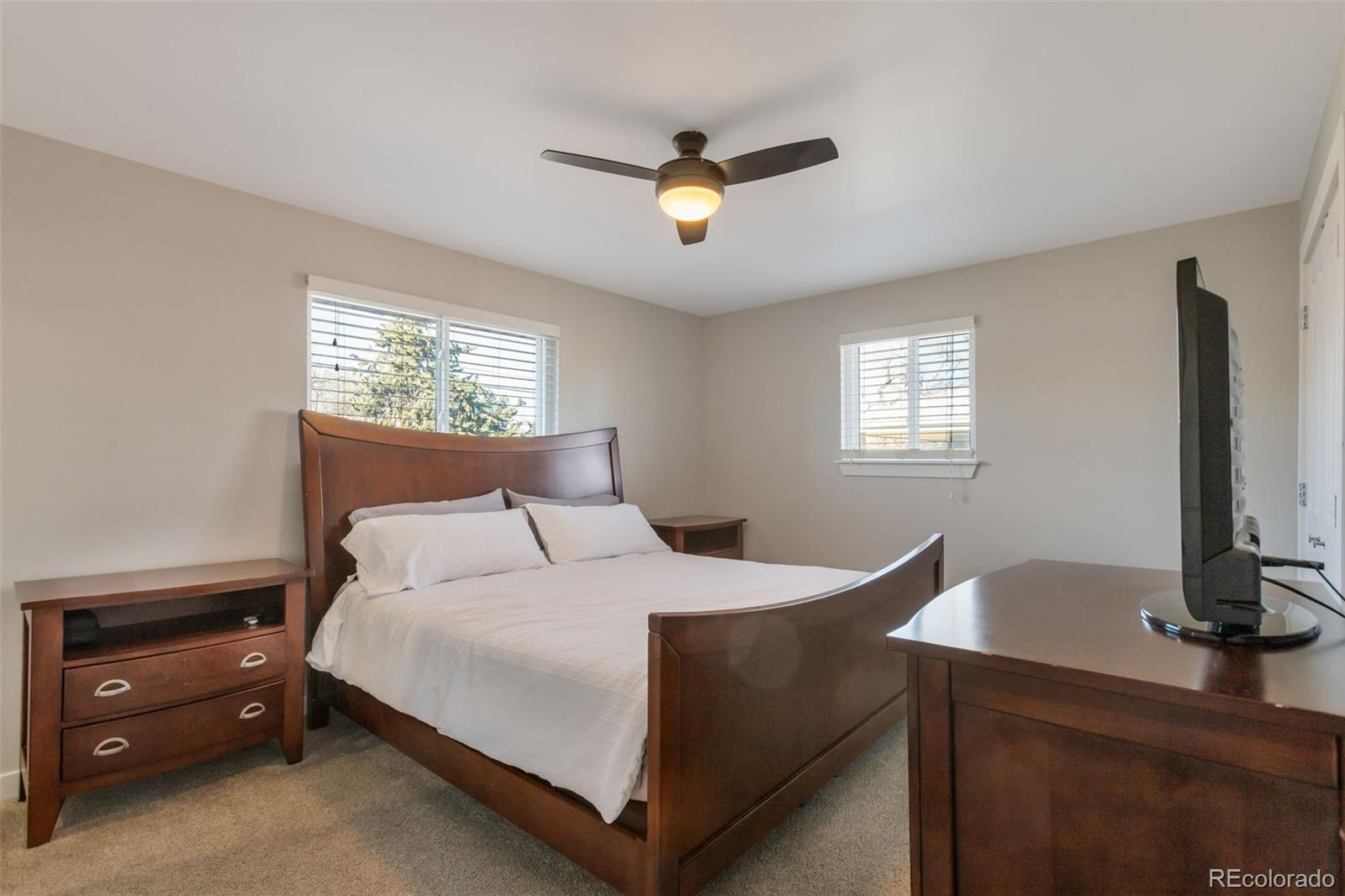 6221 South Logan Court Centennial, CO 80121 - Photo 17 of 30 a bedroom with a bed and a dresser