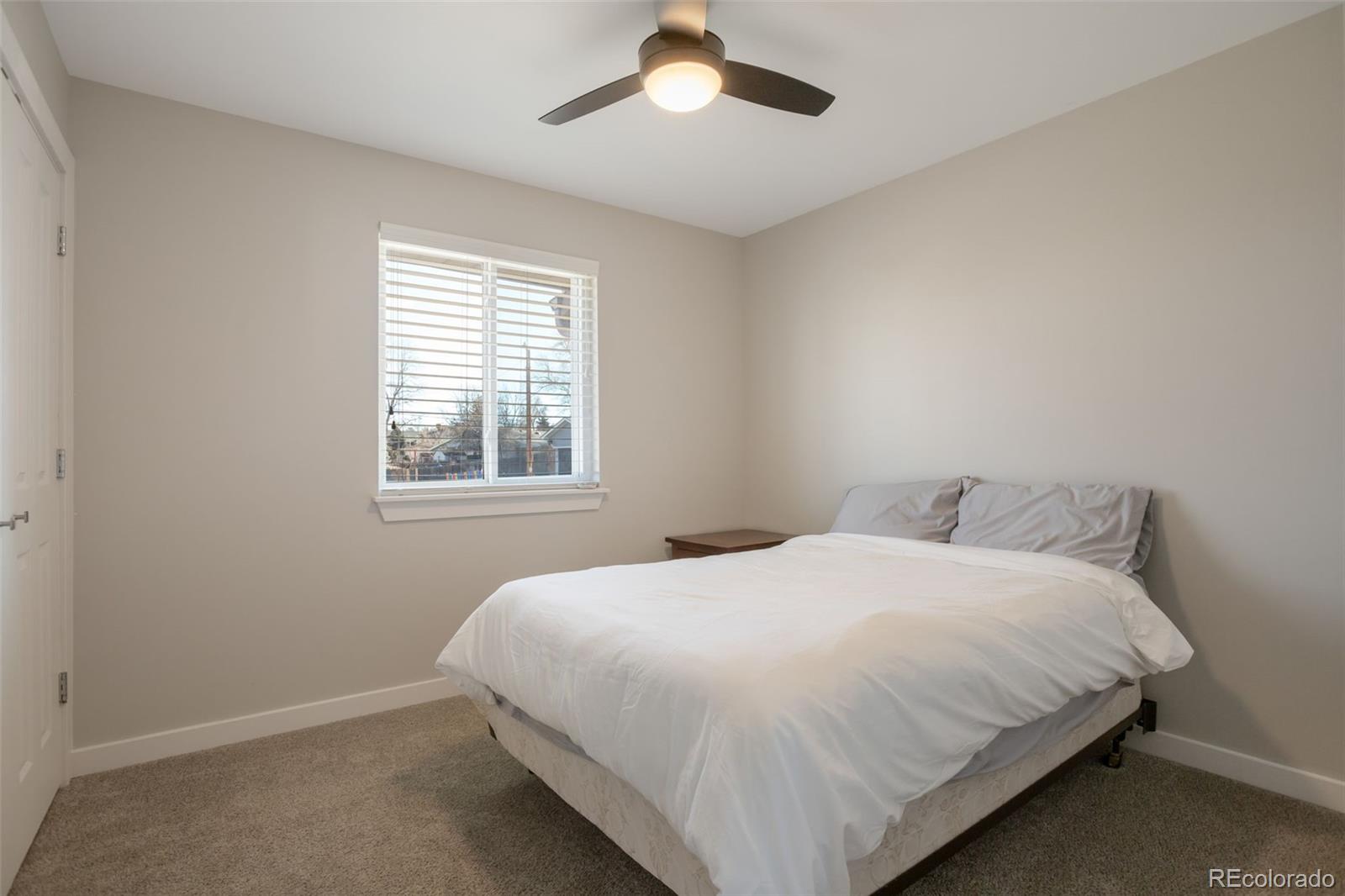 6221 South Logan Court Centennial, CO 80121 - Photo 18 of 30 a bedroom with a bed and window