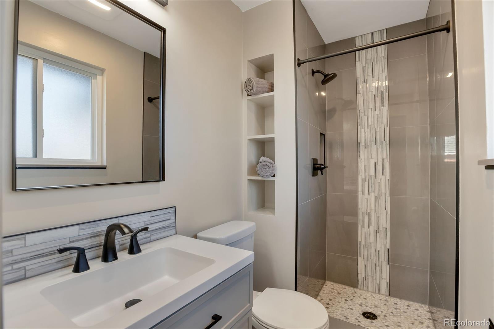6221 South Logan Court Centennial, CO 80121 - Photo 24 of 30 a bathroom with a sink toilet and shower