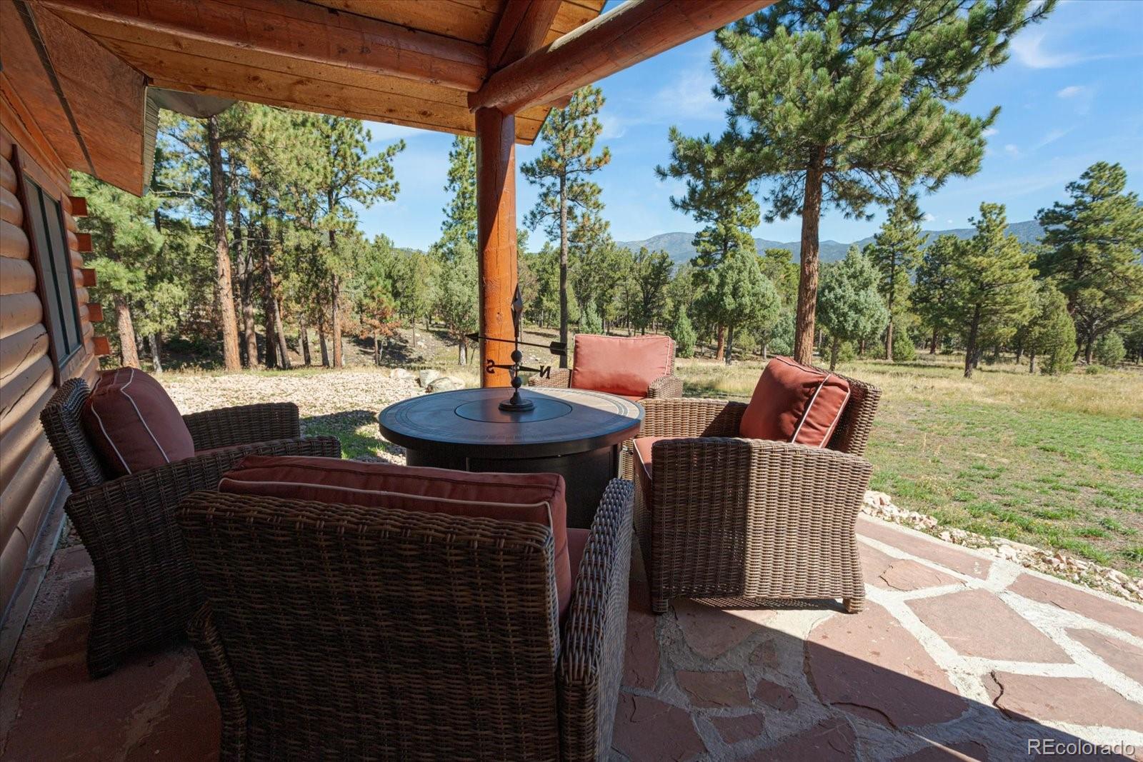 234 Bremer Road Howard, CO 81233 - Photo 36 of 50 a view of a patio with a table chairs and a floor to ceiling window next to a yard
