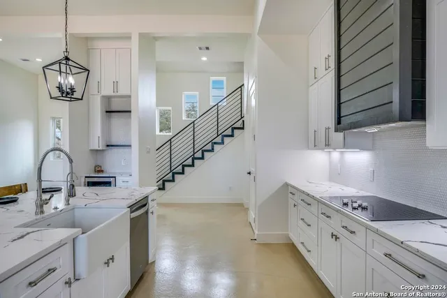 a kitchen with a sink cabinets and window