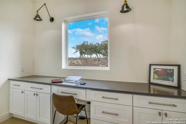 a view of workspace with a cabinet and a window