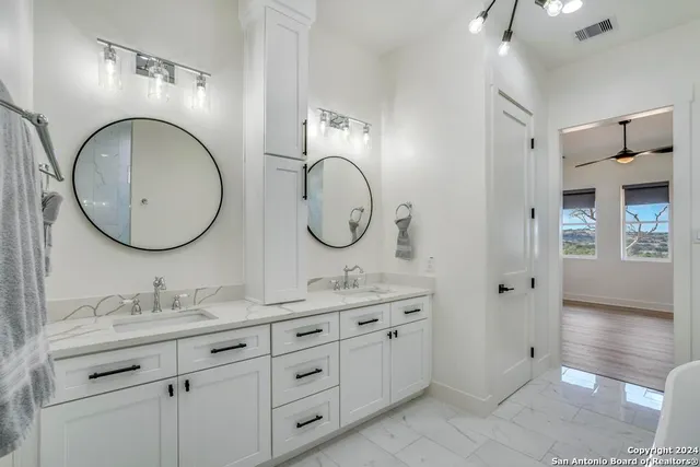 a bathroom with 2 sink and a mirror