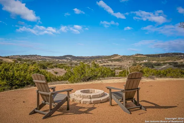 a view of a terrace with furniture and city view