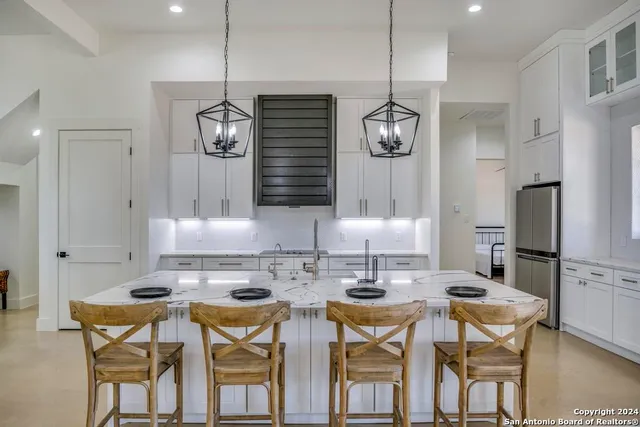 a kitchen with stainless steel appliances kitchen island granite countertop a sink and cabinets