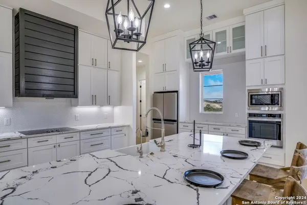 a kitchen with stainless steel appliances kitchen island granite countertop a sink and cabinets